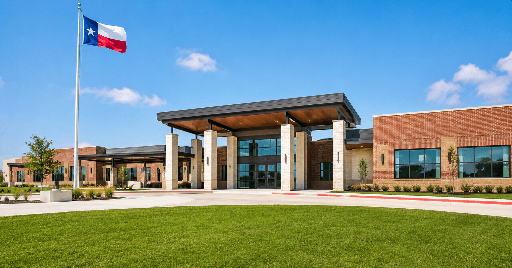 Modern Texas school building with Texas flag outside