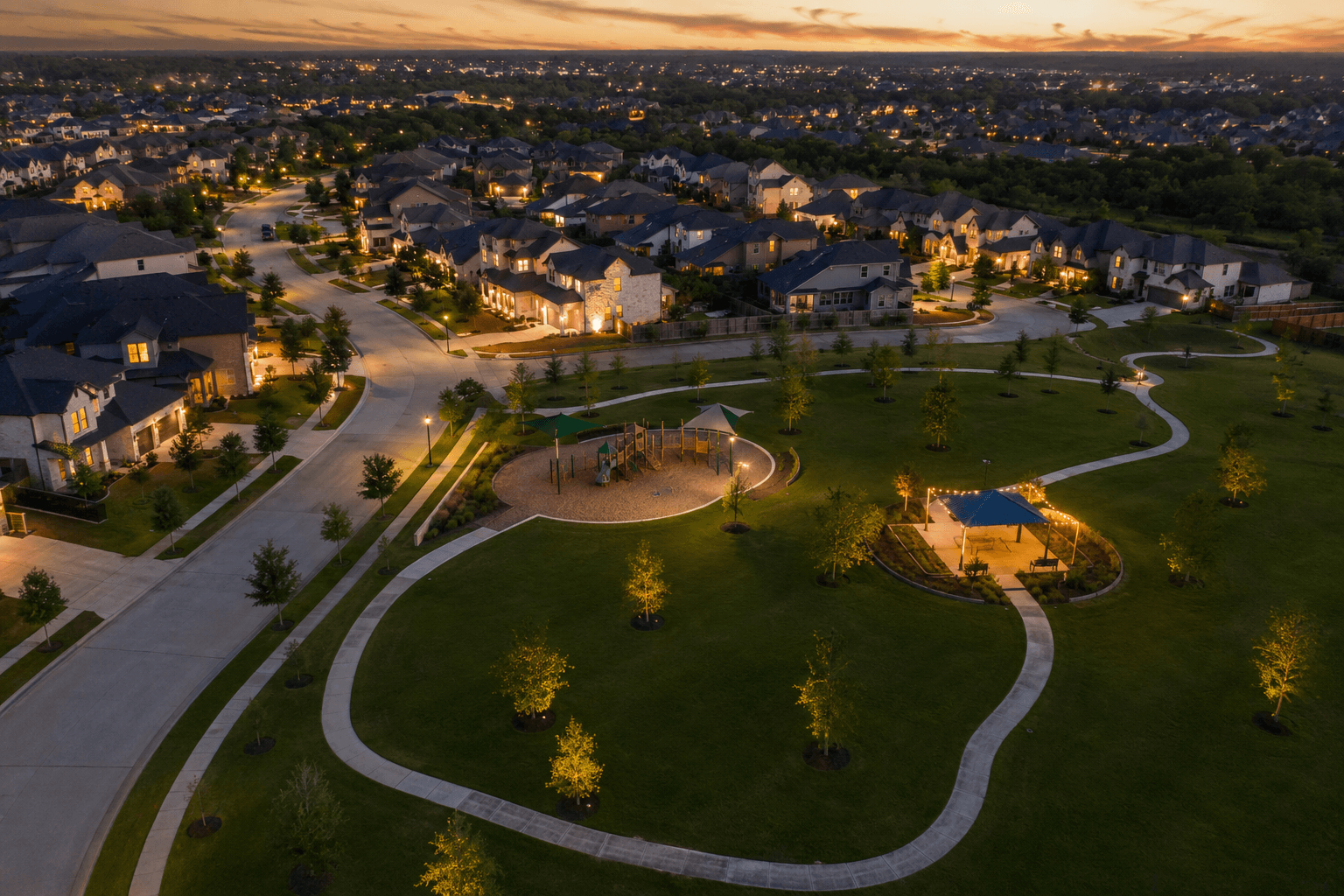 Aerial view of a new construction community near The Woodlands, Texas with a park and playground at dusk