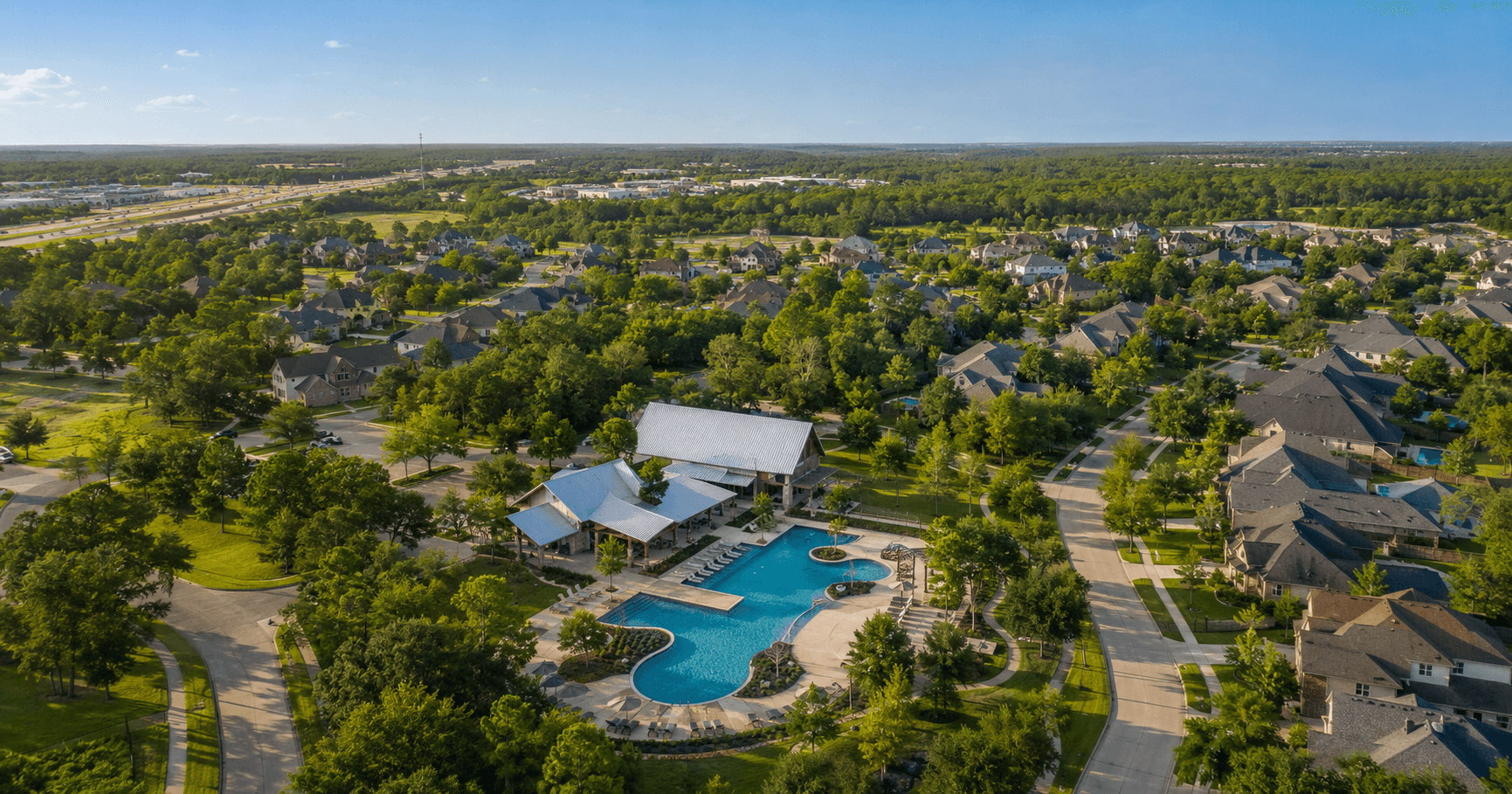 Aerial view of NorthGrove master-planned community in Magnolia TX with resort pool and established homes
